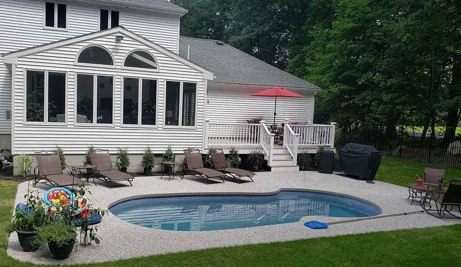 Small fiberglass pool with lounge chairs